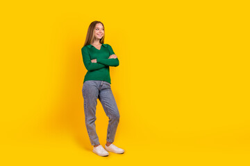 Full body photo of positive blonde hair teenager girl crossed arms looking empty space ideas brainstorm isolated on yellow color background