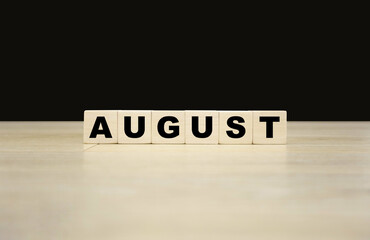 August word written on wooden blocks. August text for your desing, concept.