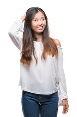Fototapeta premium Young asian woman over isolated background confuse and wonder about question. Uncertain with doubt, thinking with hand on head. Pensive concept.