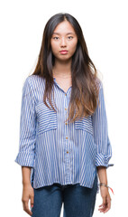 Obraz premium Young asian woman over isolated background with serious expression on face. Simple and natural looking at the camera.
