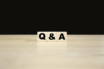 Q&A word written on wooden blocks. Q&A text for your desing, concept.