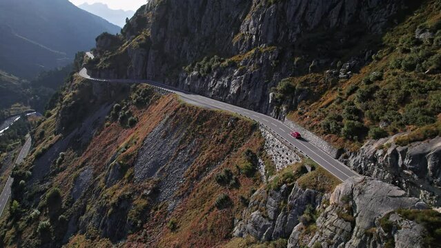 Aerial view of red car driving on mountain road, Susten Pass, Switzerland