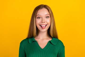 Portrait of cheerful carefree person toothy smile have good mood show tongue out isolated on yellow...