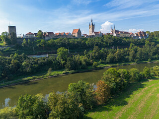 Fototapeta na wymiar Bad Wimpfen with a view of the old church and the historic city wall over fields, drone shoot