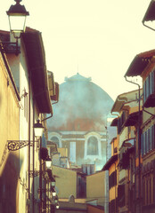 Partial view of Brunelleschi's Dome in Florence. Unusual view in a glimpse of an alley. Photo taken...
