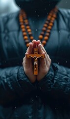 Woman praying with a Catholic cross in her hands, praying for salvation to Jesus Christ, jewelry in the form of crosses on her hands and body