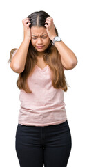 Fototapeta na wymiar Young beautiful brunette woman wearing pink t-shirt over isolated background suffering from headache desperate and stressed because pain and migraine. Hands on head.