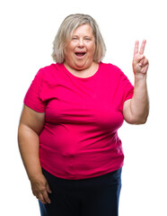 Fototapeta premium Senior plus size caucasian woman over isolated background smiling with happy face winking at the camera doing victory sign. Number two.