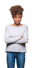 Beautiful young african american woman over isolated background skeptic and nervous, disapproving expression on face with crossed arms. Negative person.