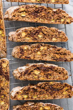 Home baked chocolate and pistachio biscotti cooling on a rack