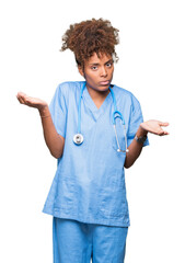 Young african american doctor woman over isolated background clueless and confused expression with...