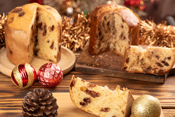 Panettone, panettone with chocolate flavors on a rustic table with Christmas decorations. Selective...