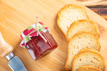 Jam and toast, jar of jam and toast on rustic wood. Selective focus.