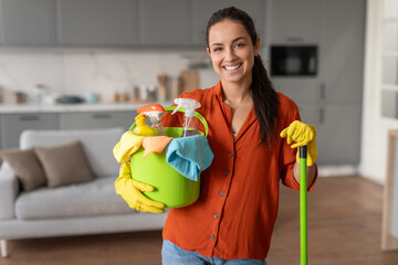 Friendly cleaner with bucket and mop ready for housework