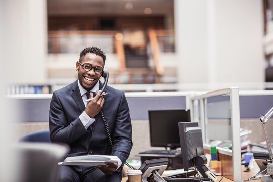 Colleagues with diverse backgrounds working, talking and hanging out in large office space. Cape Town, South Africa