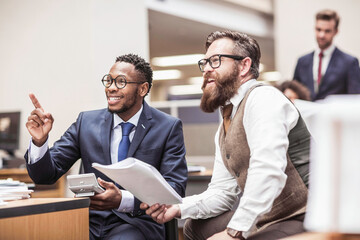 Colleagues with diverse backgrounds working, talking and hanging out in large office space. Cape Town, South Africa