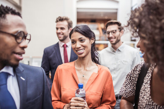 Colleagues with diverse backgrounds working, talking and hanging out in large office space. Cape Town, South Africa