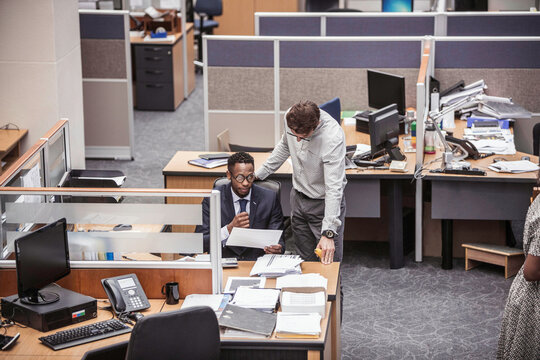 Colleagues with diverse backgrounds working, talking and hanging out in large office space. Cape Town, South Africa