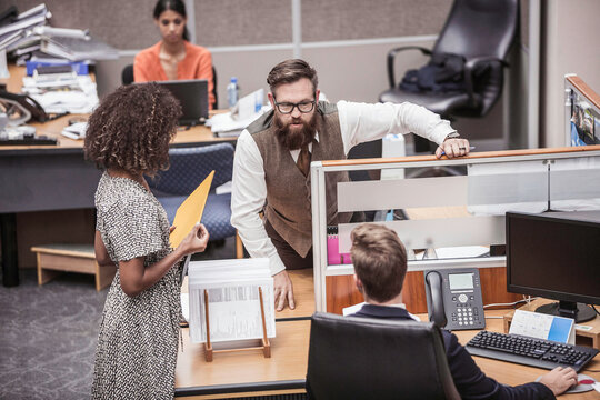 Colleagues with diverse backgrounds working, talking and hanging out in large office space. Cape Town, South Africa