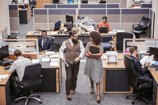 Colleagues with diverse backgrounds working, talking and hanging out in large office space. Cape Town, South Africa