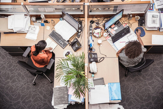 Colleagues with diverse backgrounds working, talking and hanging out in large office space. Cape Town, South Africa