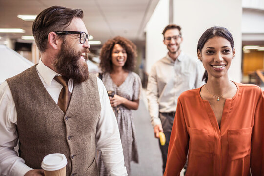 Colleagues with diverse backgrounds working, talking and hanging out in large office space. Cape Town, South Africa