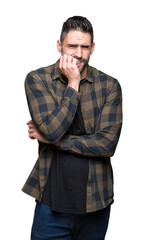 Fototapeta premium Young handsome man over isolated background looking stressed and nervous with hands on mouth biting nails. Anxiety problem.