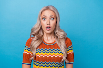 Photo of shocked funky lady wear print shirt big eyes open mouth isolated blue color background