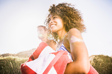 Mixed race couple having fun playing on the beach. Cape Town, South Africa