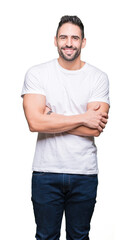 Young man wearing casual white t-shirt over isolated background happy face smiling with crossed arms looking at the camera. Positive person.