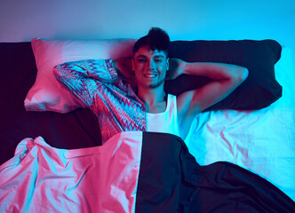 Portrait of contrasts. Aerial view. Young male model expressing gender attitudes, where two halves...