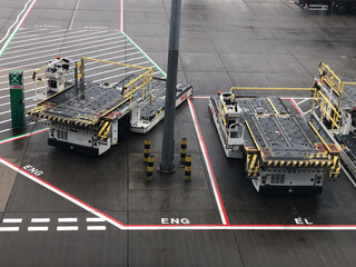 Container loader and transporters at rest on airport runway - 711574328