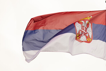 Flag of Serbia. A large Serbian flag flutters in the wind. Close-up. Great for news. National Flag of Serbia on a white background