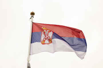 Flag of Serbia. A large Serbian flag flutters in the wind. Close-up. Great for news. National Flag of Serbia on a white background