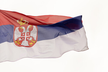 Flag of Serbia. A large Serbian flag flutters in the wind. Close-up. Great for news. National Flag of Serbia on a white background