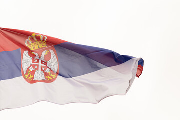 Flag of Serbia. A large Serbian flag flutters in the wind. Close-up. Great for news. National Flag of Serbia on a white background
