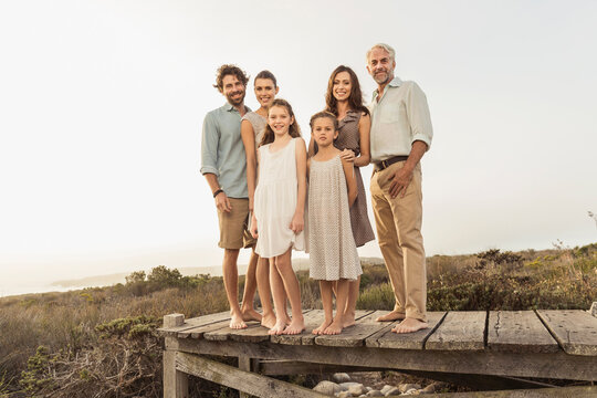 Family portrait outside on a boardwalk at a beach house