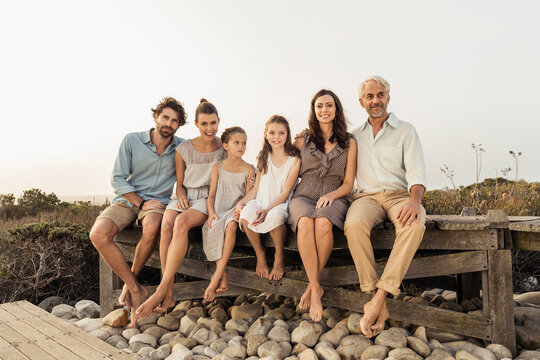 Family portrait outside on a boardwalk at a beach house