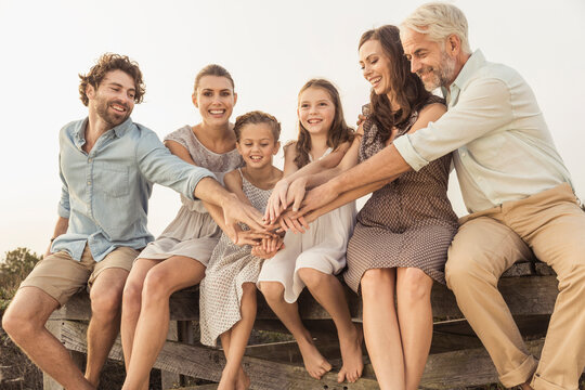 Family portrait outside on a boardwalk at a beach house
