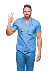 Handsome young doctor surgeon man over isolated background showing and pointing up with fingers number three while smiling confident and happy.