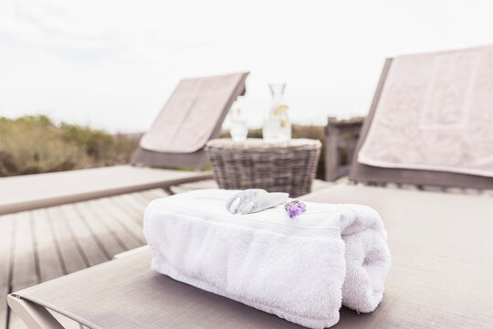 Towel and flowers on a chaise lounge at the pool