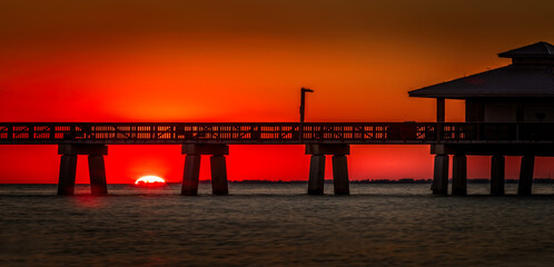 Sunset behind the pier of Fort Myers Beach, Florida USA