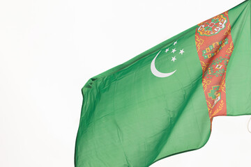 State flag of Turkmenistan. A large State flag of Turkmenistan flutters in the wind. Close-up. Great for news. National flag of Turkmenistan on a white background