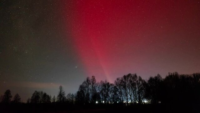 Northern lights timelapse over Ukraine. Red coloured lights in sky