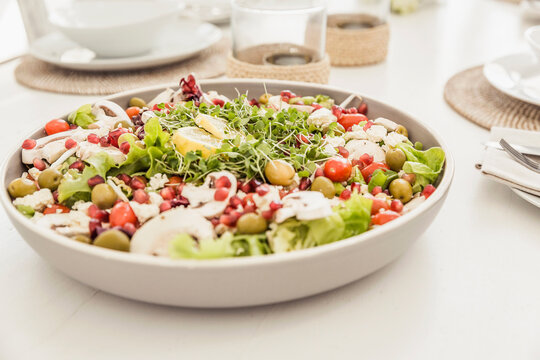 Beautiful healthy salad on white shabby chic dinner table