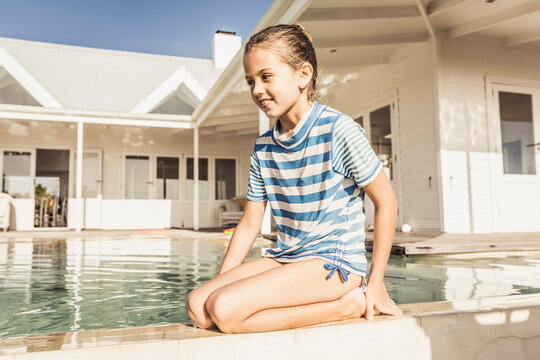 Girl having fun playing in the pool on the patio of a vacation home
