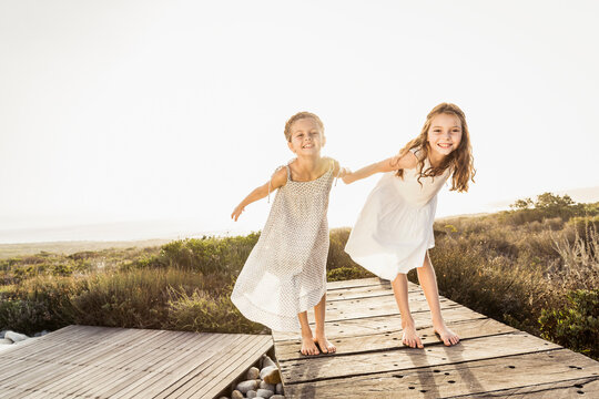 Two girls having fun playing in the pool and on the patio of a vacation home
