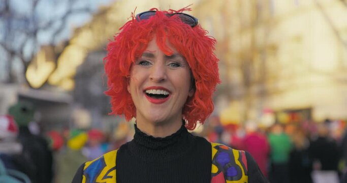 Carnival - Cheerful costumed woman making a kissy face and then laughing. Handheld shot. Slow-mo.