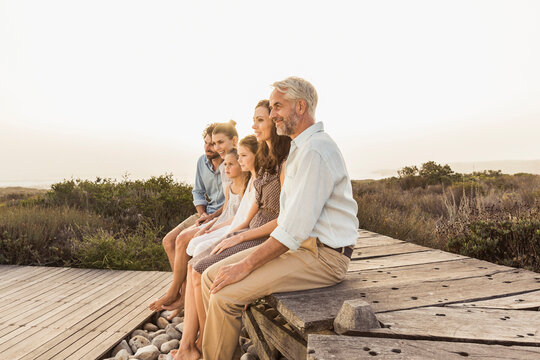 Family walking and posing on a boardwalk during family reunion at a vacation rental