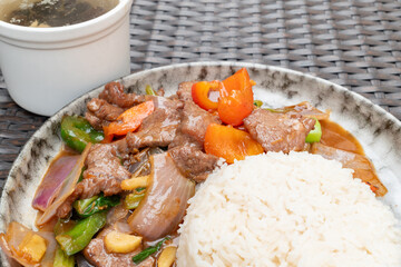 angle view beef with sweet pepper and onion and rice and soup at horizontal composition